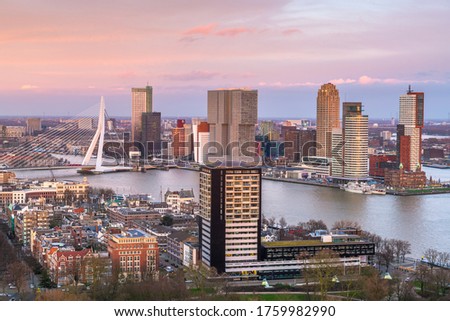 Rotterdam, Netherlands, city skyline over the Nieuwe Maas River at twilight.
