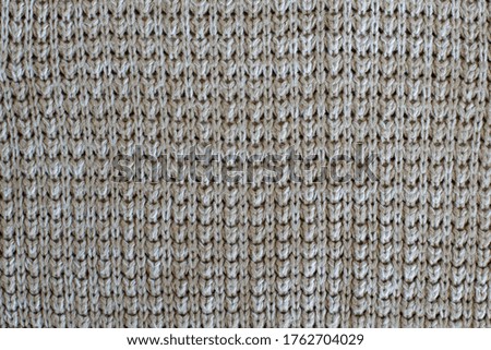 beautiful texture of beige knitted clothing