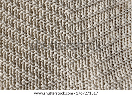 Textural white background. Knitted wool fabric texture.