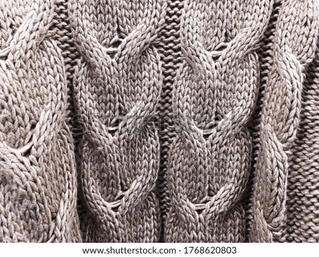 Classic knitted fabric wool texture for background. Close up of white knitted material pattern for design. Blue warm sweater textile background. 


