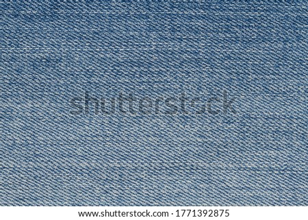 Blue jeans denim material background with copy space for message or use as a texture 