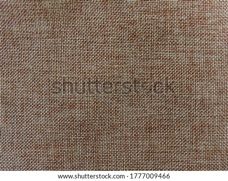Brown natural linen fabric or canvas as background texture