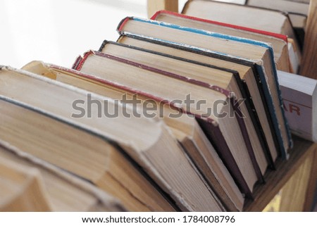 multicolored vintage books on wooden shelf
