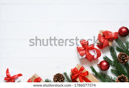 Christmas card. Christmas layout with boxes and fir on a white wooden background.