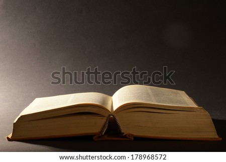 Old open book with bright light from left side