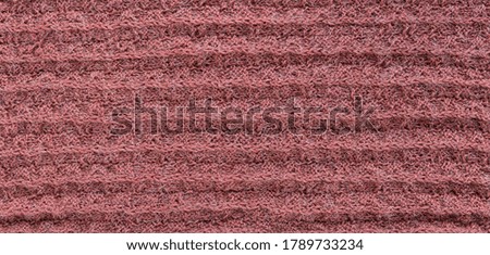 Hand-knitted wool coral fabric texture as background. Banner. Top view