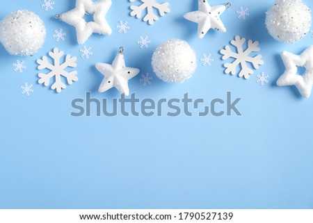 Christmas frame top border of white snowflakes, balls, snowflakes on blue background. New Year, winter holidays greeting card template, Christmas poster mockup.