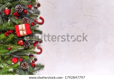 Christmas white grunge background, top view, decorated with fir twigs, berries, baubles. Christmas, New Year decoration, pine tree branches and cones on light background, flat lay, copy space.