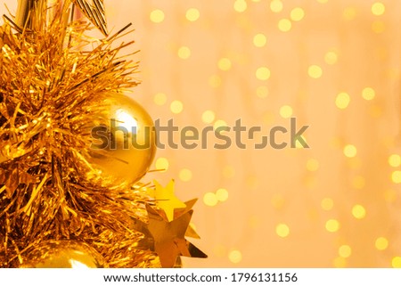 Gold Christmas balls, Gold tree Christmas on a gold bokeh background