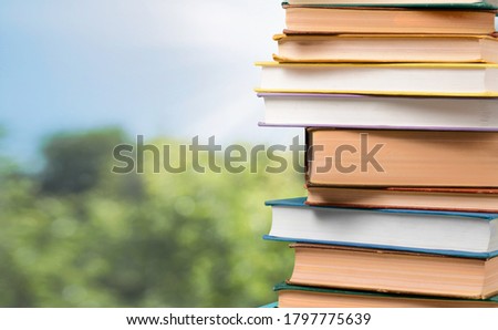 Stack of colored library books on desk