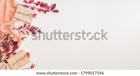 Flat lay composition with colorful autumn leaves and gift box on color background