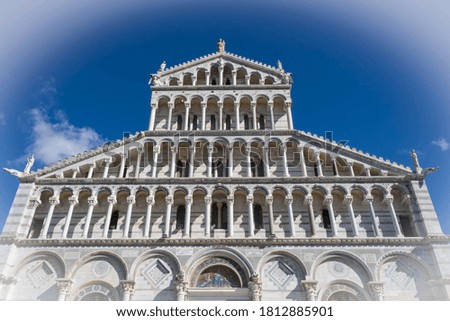 Scenic view of Pisa Cathedral upper front against blue sky. White vignette.