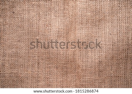A top view of natural hessian material texture background fabric.