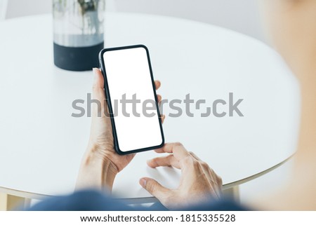 cell phone mockup blank white screen.woman hand holding texting using mobile on desk at coffee shop.background empty space for advertise.work people contact marketing business,technology 