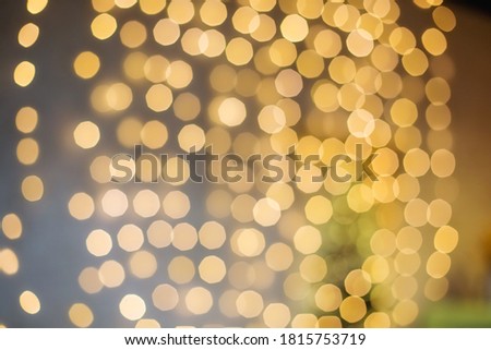 Bright Golden bokeh lights garland background. New year and Christmas. Abstract holiday background.