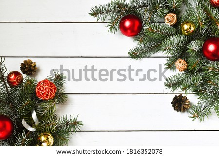Christmas composition on a white wooden background. Fir branches and toys.Copy space for your congratulations.New year, christmas concept.