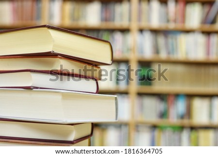 Stacked books on a desk in the library