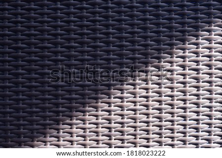 Over light Texture synthetic rattan weaving for background.