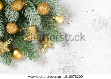 Christmas banner with a Christmas tree and gold decorations on a light background. Copyspace
