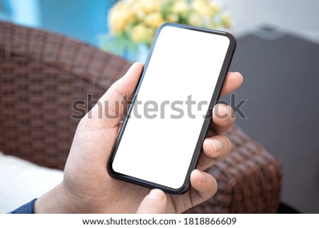 male hand holding phone with isolated screen in room house