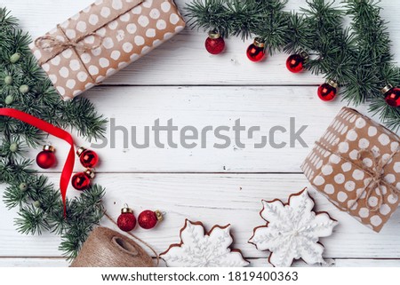 White wooden background with coniferous branches and Christmas decorations