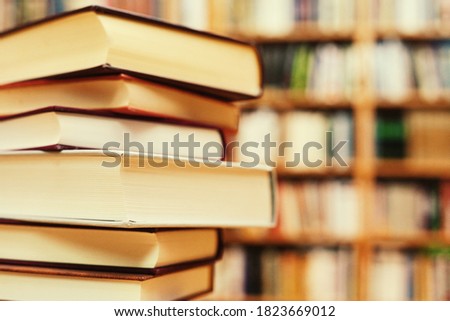 Stacked books on a desk in the library
