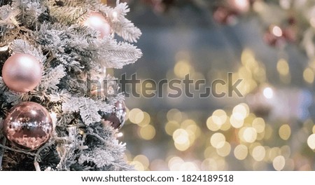 Merry christmas card. Christmas tree decorated with golden balls on defocused blurred, sparkling, magic background. New Year decoration on bokeh backdrop. Copy space.