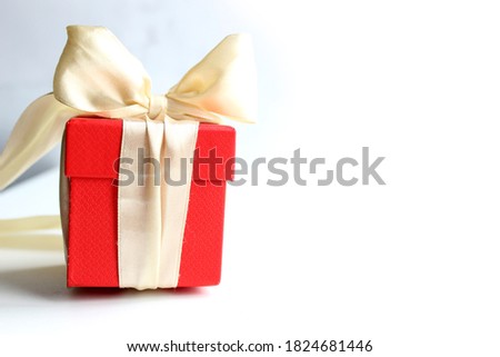 Red gift box with a bow on a light background. sales