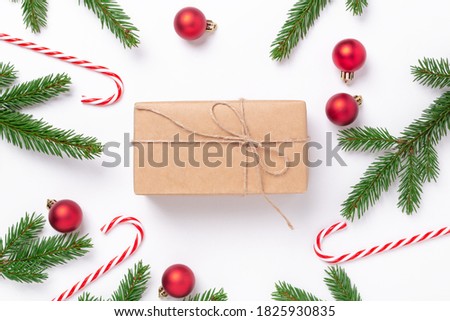 Christmas composition with fir tree branches, decoration and present box on white background. Top view. Copy space - Image