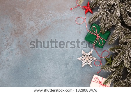 Christmas composition fir tree branches, star decor on blue background.