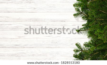 Fir tree branches and old wooden table