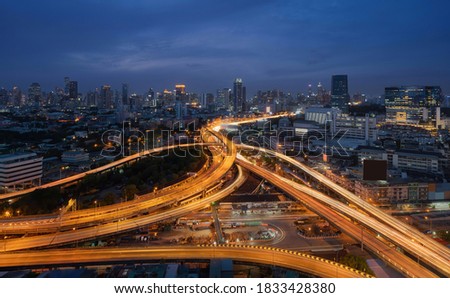 Aerial view of cars driving on highway junctions. Bridge street roads in connection network of architecture concept. Top view. Urban city, Bangkok at night, Thailand.