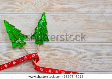 Sweet homemade christmas tree shaped lollipops, children's holiday sweets and dessert, new year's food concept, funny kid's candies