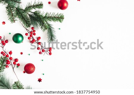 Christmas composition. Fir tree branches, red and green decorations on white background. Christmas, winter, new year concept. Flat lay, top view, copy space