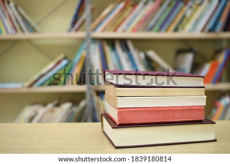 Stack of books on the table in library