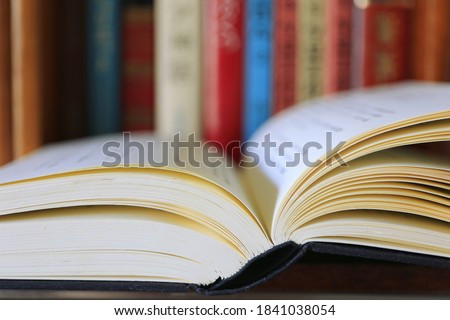 Books open on the table in the library Books arranged in the background selective focus and shallow depth of field