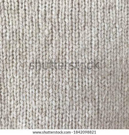 Off-white knit sweater material with chunky yarn
