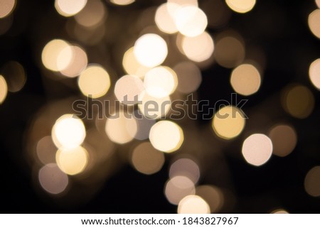 abstract blurred tungsten bokeh light in the dark night as festive background