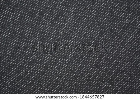 black fabric with a small white speck