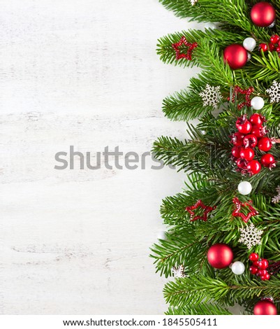 Christmas border with fir branches and  baubles on white shabby wooden board with copy space for text. Flat lay.  New Year holiday  background.