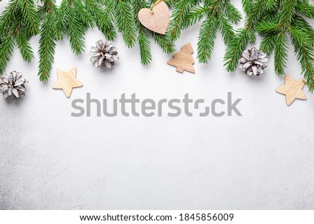 Christmas composition with fir tree branches and natural decor on stone background - Image