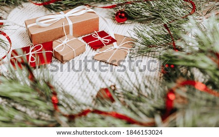 New year gifts on knitted background with christmas tree and toys