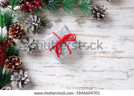 Gift and fir branches on a wooden table. Christmas and New Year concept