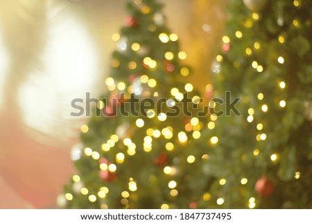 Christmas tree on abstract light bokeh background.