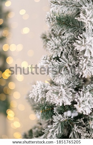 Christmas tree in the snow with festive lights