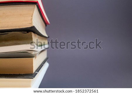 a stack of some books against a grey background