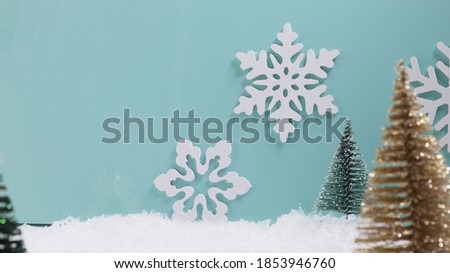 New Year card, artificial trees on a blue background with snow