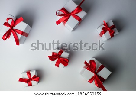 White gifts with red ribbons flat lay. Set of gift box isolated on white background.Christmas gift boxes. Merry Christmas and Happy Holidays greeting card, frame, banner. Panorama