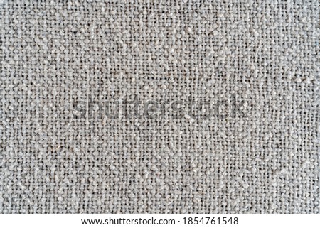 The texture of a dense white woolen fabric. Close-up textile background.
