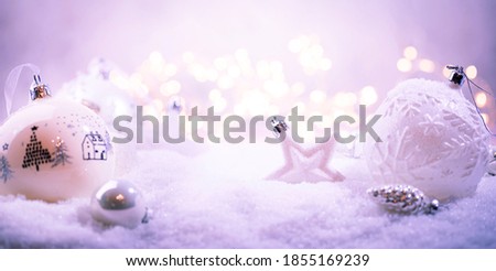 Christmas white decorations on snow with christmas lights. Winter Decoration Background